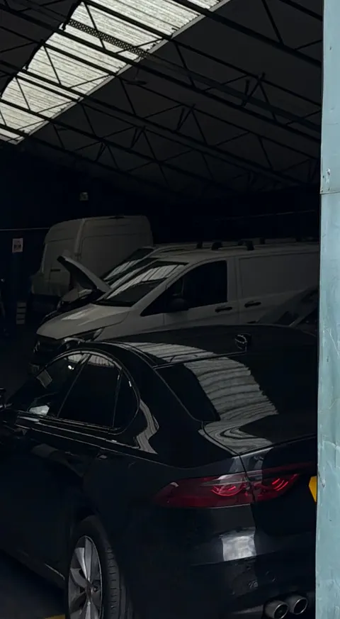 Cars and vans inside the DWAL Motors workshop